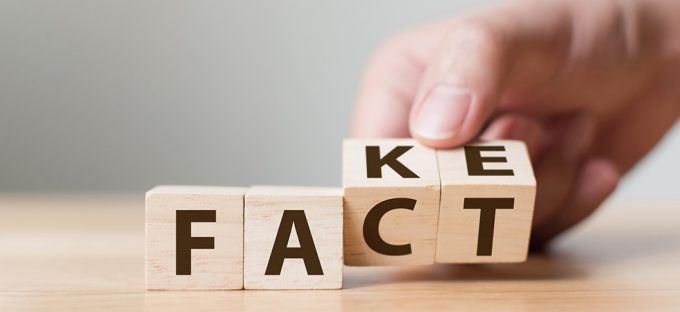 Fake vs Fact blocks being turned by hand